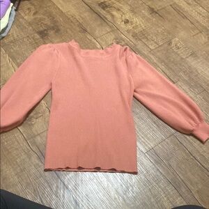 Woman’s pink sweater